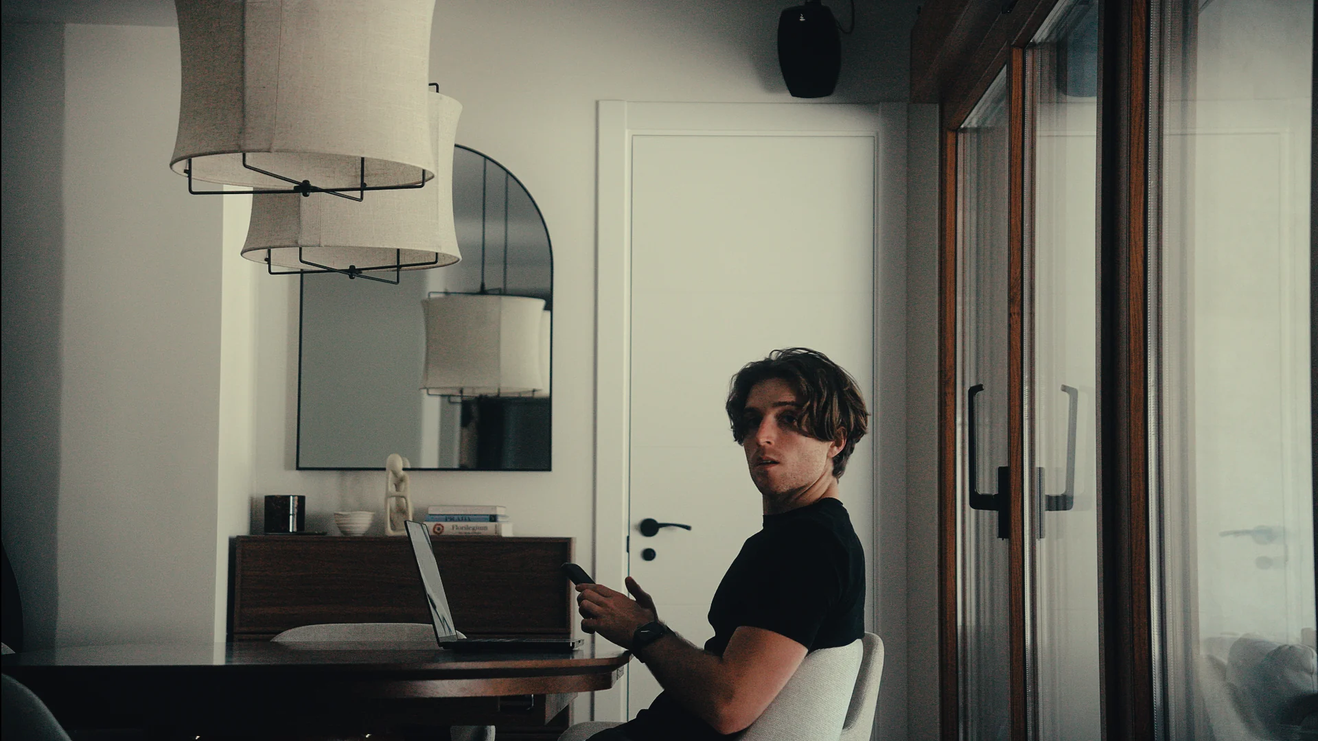 Alex Megino seated at his desk looking toward the camera